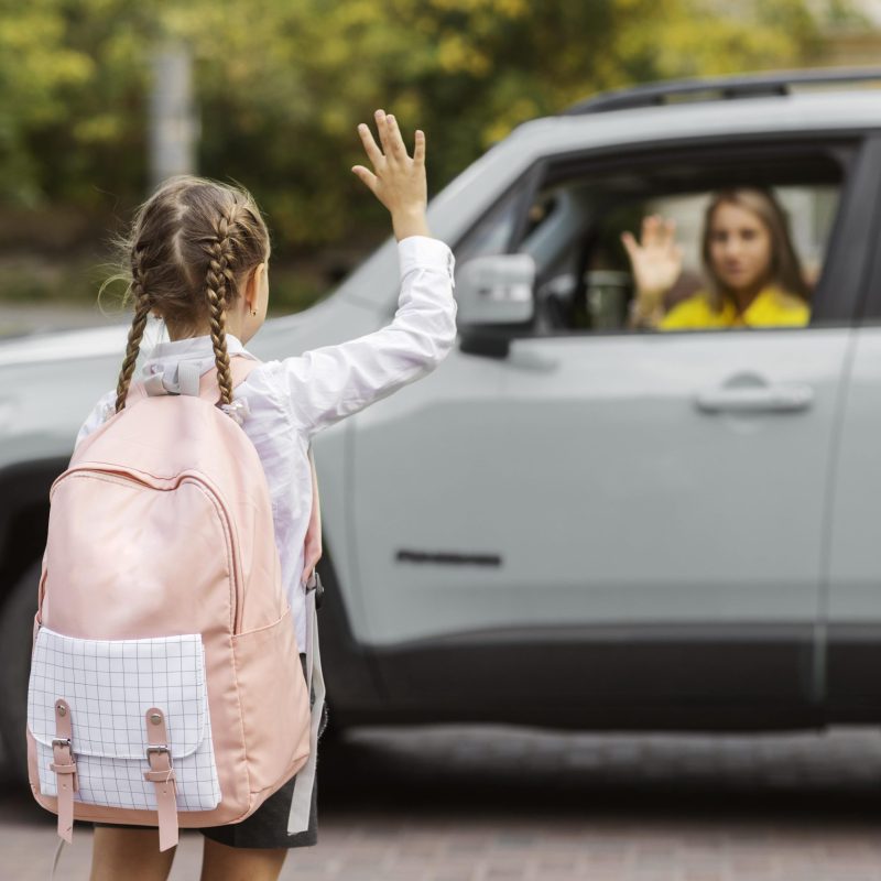 back-view-girl-waving-mother-min